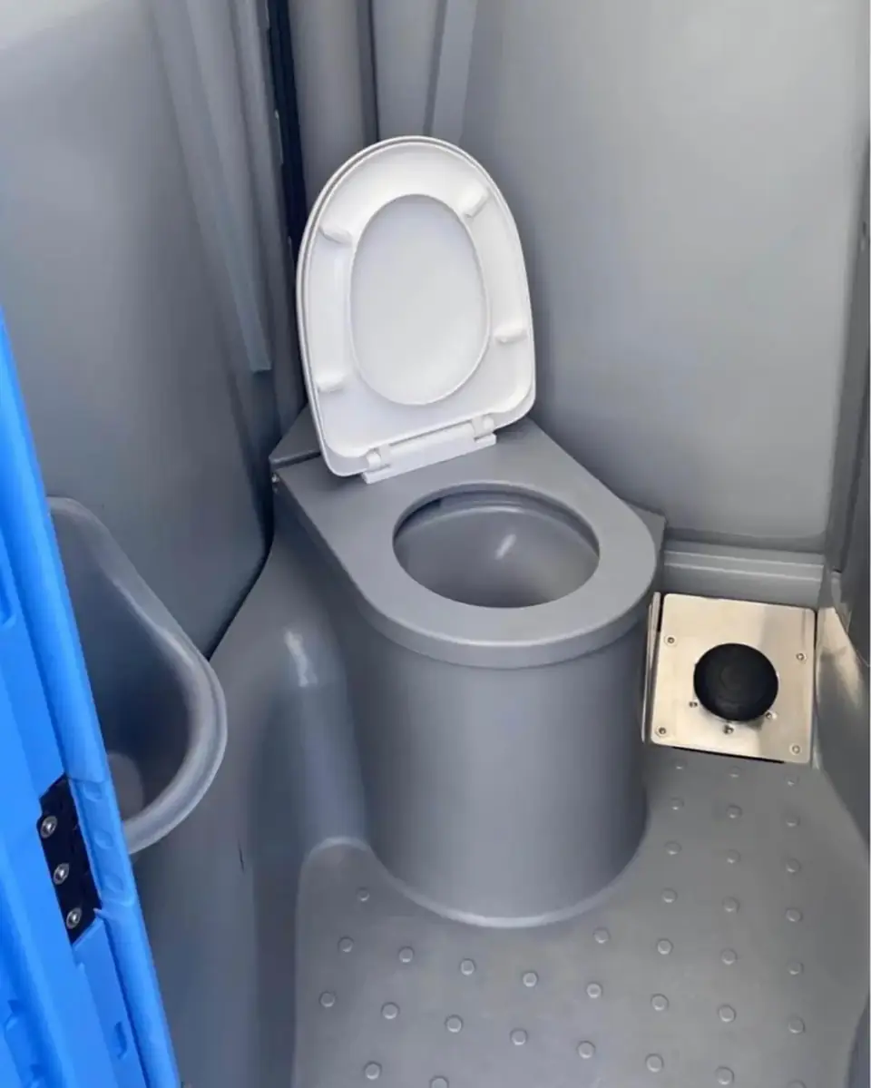 Toilet seat inside a gray deluxe flushing porta potty